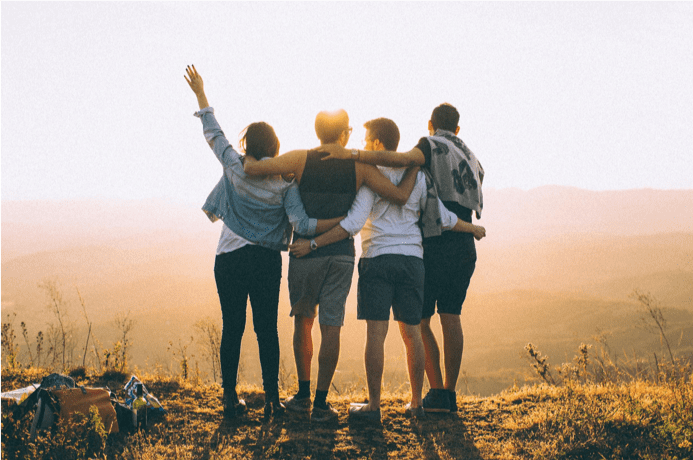 group of young men outdoors looking at sunset