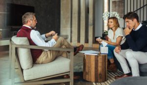 couple talks with therapist in family therapy