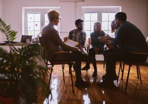 patients in circle in group therapy for addiction