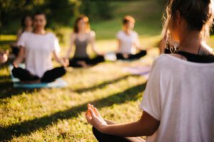 people sit outdoors in holistic therapy