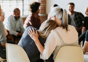 women comfort each other while in an IOP program for addiction