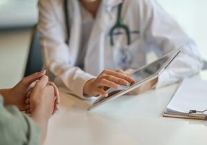 doctor talks with patient about mat therapy